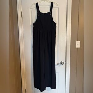 Black boutique overalls with adjustable button straps and pockets